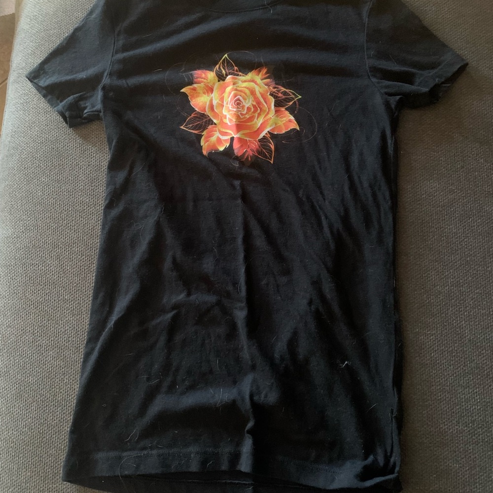 Black, slim fit T-shirt, with a orange flower